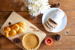 Pie, pastry, and bread roll on a table