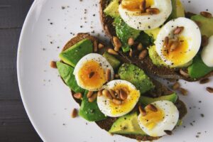 Avocado toast with boiled egg on a plate