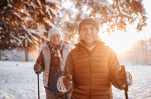 Older couple walking through snowy woods
