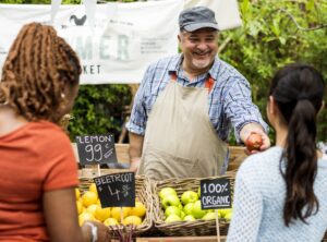 Man selling fresh produce at a farmers market